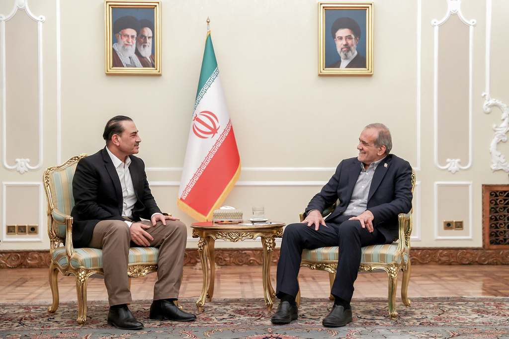 In this photo released by the Iranian Presidency Office, President Masoud Pezeshkian, right, meets Pakistan's Army Chief Field Marshal Gen. Asim Munir in Tehran, Iran, Monday, Aug. 24, 2026. (Iranian Presidency Office via AP)