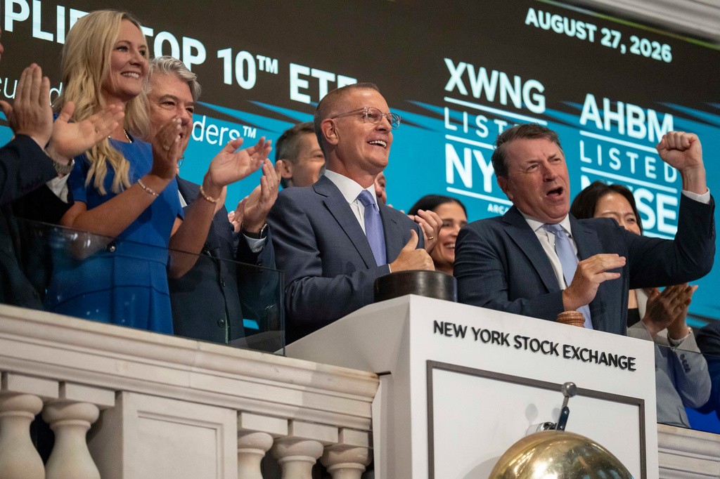 Christian Magoon, center, CEO of Amplify ETFs rings the opening bell on the floor of the New York Stock Exchange, Thursday, Aug. 27, 2026, in New York. (AP Photo/Yuki Iwamura)