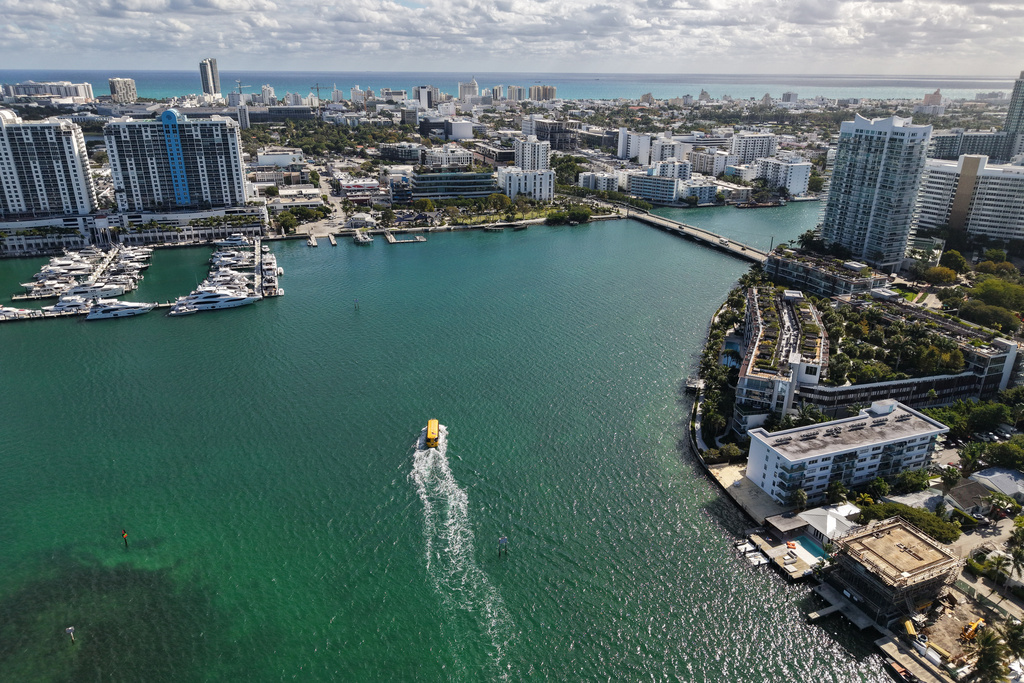 The Miami Beach Water Taxi glides along Biscayne Bay towards Miami Beach, Fla., Tuesday, Jan. 20, 2026. (AP Photo/Daniel Kozin)