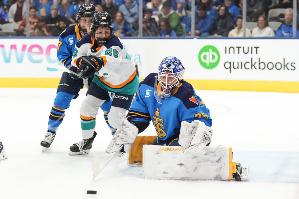 Toronto Sceptres goaltender Elaine Chuli makes a stop as New York Sirens' Casey O'Brien closes in during the first period of an PWHL hockey game, in Toronto, Tuesday Jan. 6, 2026. (Chris Young/The Canadian Press via AP)