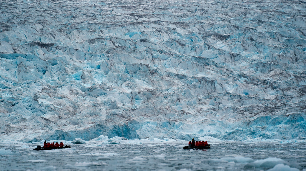 FILE - Two groups from the Poseidon Expeditions tour company look at a glacier in the Scoresby Sund, Sept. 7, 2023, in Greenland. (AP Photo/Chris Szagola, File)