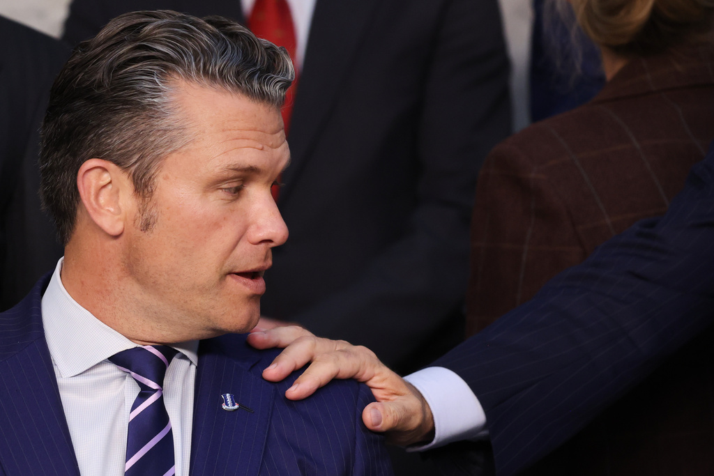 Italy's Defense Minister Guido Crosetto puts his hand on the shoulder of United States Defense Secretary Pete Hegseth during a group photo of NATO defense ministers at NATO headquarters in Brussels, Wednesday, Oct. 15, 2025 (AP Photo/Omar Havana)