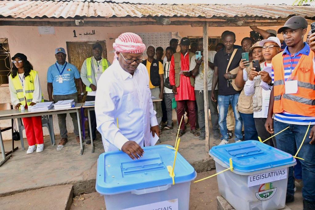 In this photo released by the Communication office Presidency republic of Guinea Bissau, incumbent President Umaro Sissoco Embalo casts his votes at a polling station during the Presidential and legislative elections in Bissau, Guinea-Bissau, Sunday, Nov. 23, 2025. (Communication office Presidency republic of Guinea Bissau via AP)