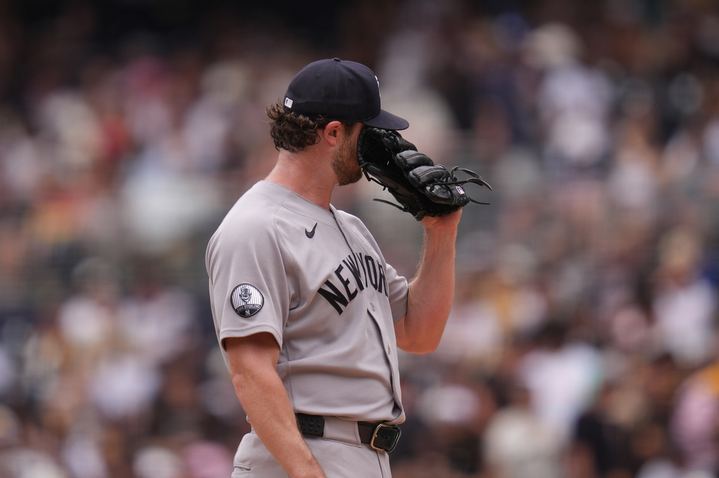 New York Yankees starting pitcher Gerrit Cole wipes his face with his glove after giving up three home runs during the first inning of a baseball game against the San Diego Padres Sunday, Sept. 6, 2026, in San Diego. (AP Photo/Gregory Bull)