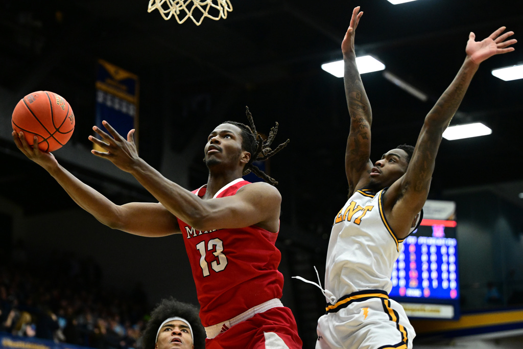 Miami forward Antwone Woolfolk goes to the basket against Kent State guard Cian Medley during the first half of an NCAA college basketball game, Tuesday, Jan. 20, 2026, in Kent, Ohio. (AP Photo/David Dermer)