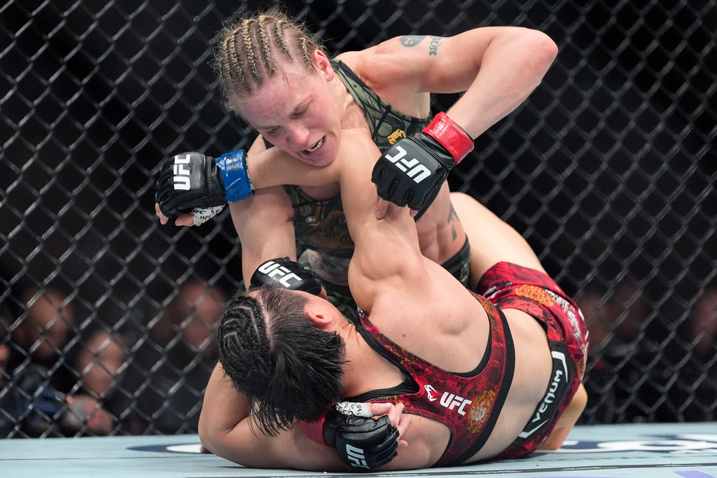 Kyrgyzstan's Valentina Shevchenko, top, grapples with China's Zhang Weili during the fifth round of a women's flyweight title bout at a UFC 322 mixed martial arts event, Saturday, Nov. 15, 2025, in New York. (AP Photo/Yuki Iwamura)