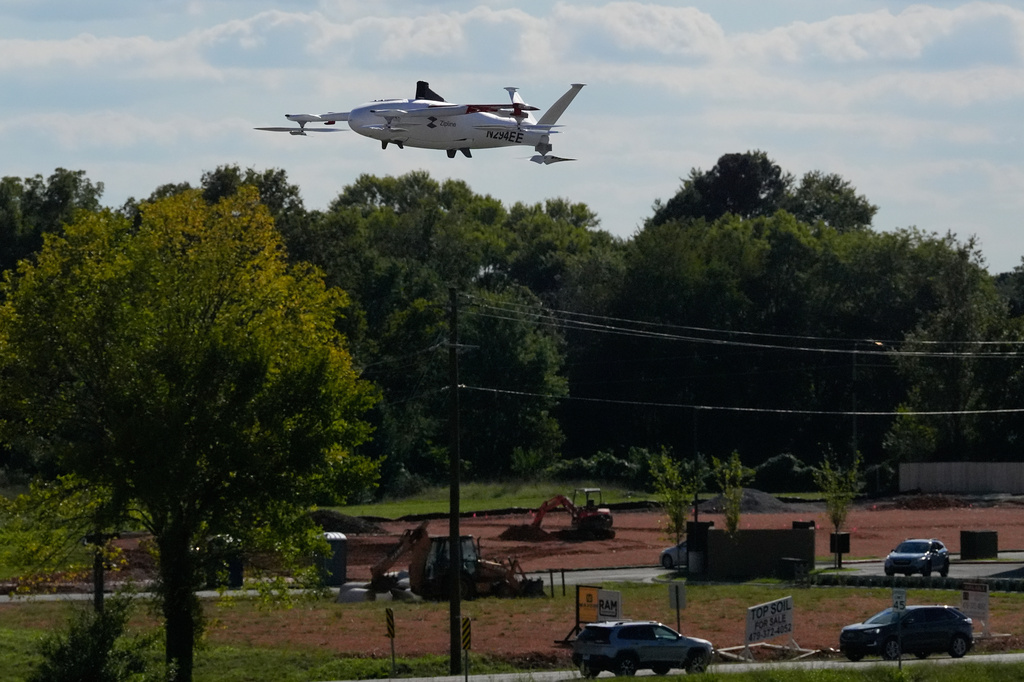 A drone operated by Zipline flies to make a delivery from a Walmart store in Pea Ridge, Ark., Friday, Sept. 26, 2025. (AP Photo/Charlie Riedel)