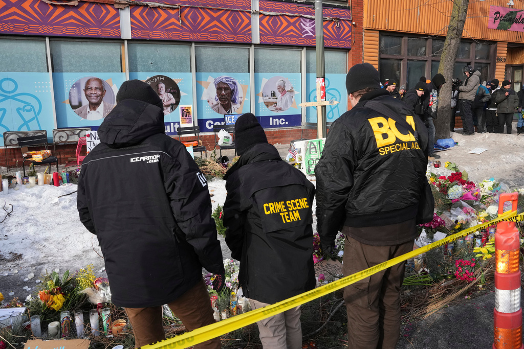 BCA officers stand on the scene where Alex Pretti was fatally shot by a U.S. Border Patrol officer yesterday, in Minneapolis, Sunday, Jan. 25, 2026. (AP Photo/Adam Gray)