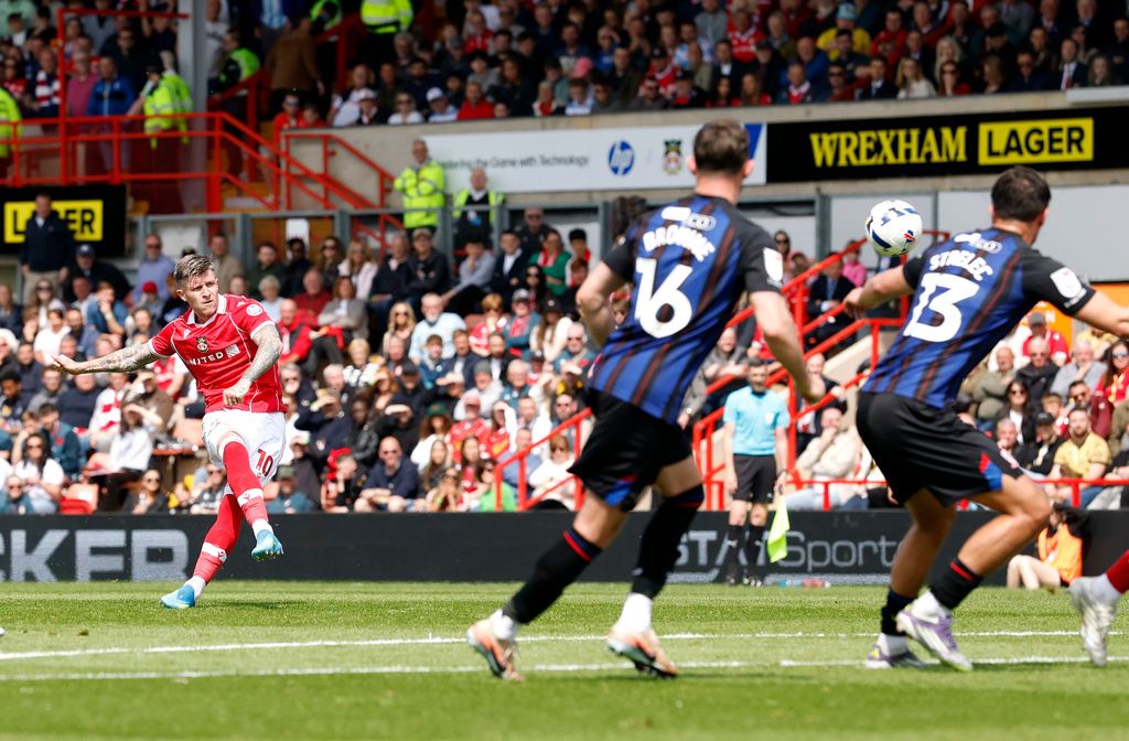 Wrexham's Josh Windass, left, scores their side's first goal of the game during the EFL Championship soccer match between Wrexham and Middlesbrough, in Wrexham, Wales, Saturday May 2, 2026. (Cody Froggatt/PA via AP)