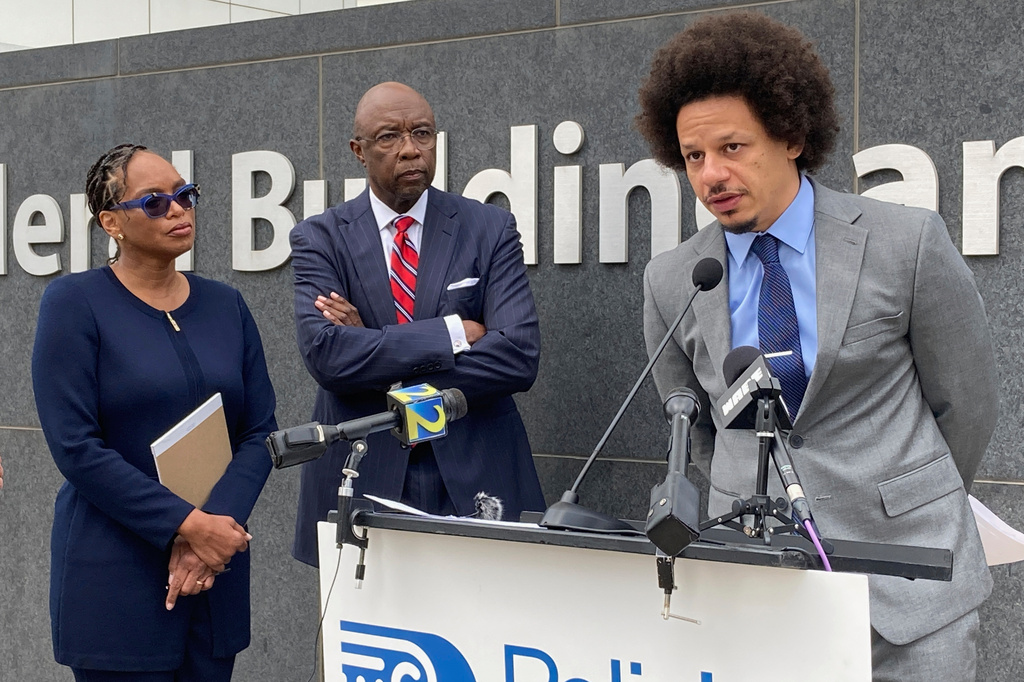 FILE - Comedian Eric André, right, speaks at a news conference outside the federal courthouse in Atlanta on Oct. 11, 2022, as his attorneys Allegra Lawrence-Hardy, left, and Richard Deane watch. (AP Photo/Kate Brumback, File)