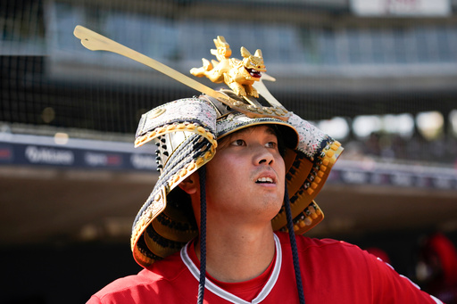 FILE - Los Angeles Angels' Shohei Ohtani celebrates wearing a Kabuto samurai warrior helmet after his home run against the Detroit Tigers during the fourth inning in the second baseball game of a doubleheader, Thursday, July 27, 2023, in Detroit. (AP Photo/Paul Sancya, File) FILE - Los Angeles Angels' Shohei Ohtani celebrates wearing a Kabuto samurai warrior helmet after his home run against the Detroit Tigers during the fourth inning in the second baseball game of a doubleheader, Thursday, July 27, 2023, in Detroit. (AP Photo/Paul Sancya, File)