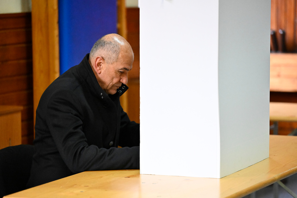 Former Slovenian Prime Minister Janez Jansa fills his ballot at a polling station for parliamentary elections in Arnace, Slovenia, Sunday, March 22, 2026. (AP Photo/Denes Erdos)