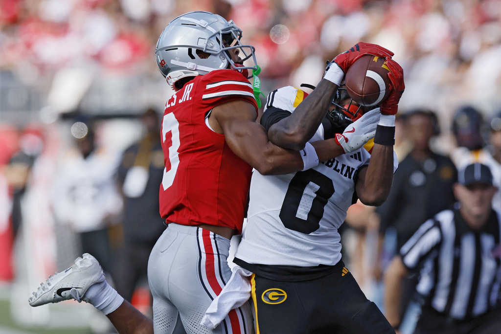 Grambling State receiver Keith Jones, right, makes a catch against Ohio State defensive back Lorenzo Styles, left, during the first half of an NCAA college football game, Saturday, Sept. 6, 2025, in Columbus, Ohio. (AP Photo/Jay LaPrete)