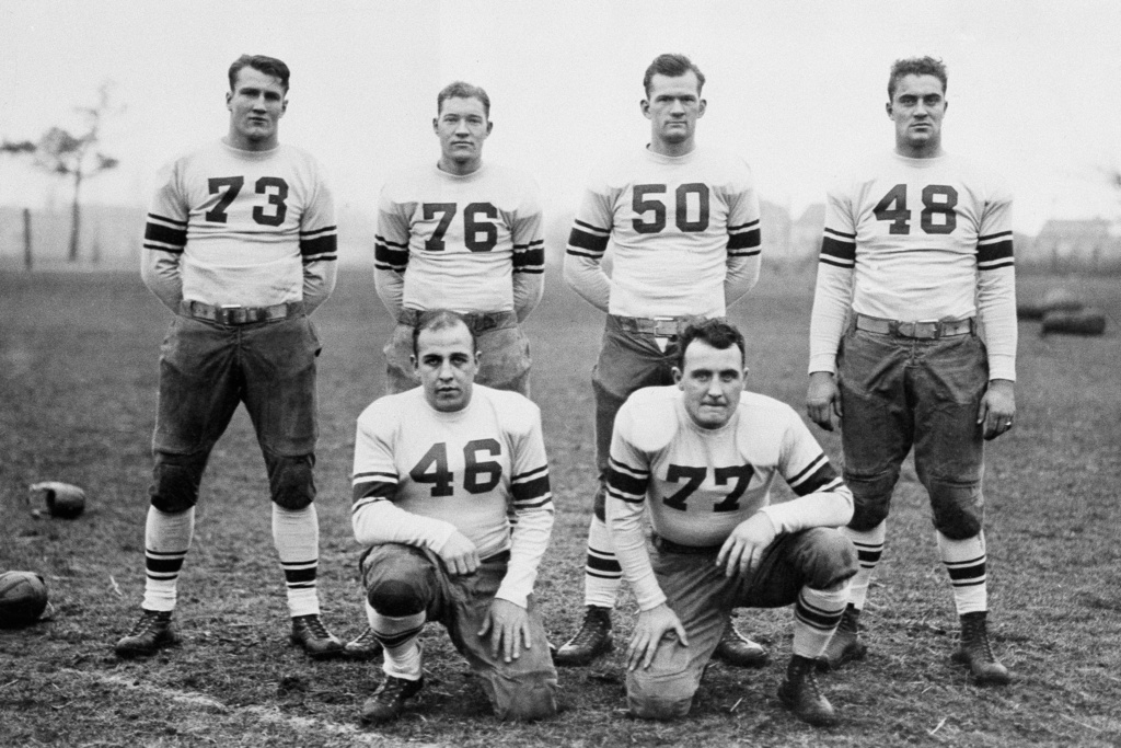 Six outstanding stars on Coach Hanley's squad that will represent the East in the East-West Game at San Francisco on New Year's Day pose Dec. 17, 1929. They are, standing from left, Bronko Nagurski, Minnesota; Tony Holm, Alabama; Elmer Sleight, Purdue, Ted Twomey, Notre Dame: kneeling from left, Willis Glasgow, Iowa; and Jack Cannon, Notre Dame. (AP Photo/File)