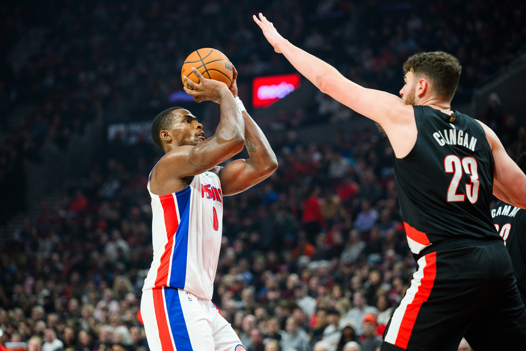 Detroit Pistons center Jalen Duren (0) looks to shoot past Portland Trail Blazers center Donovan Clingan (23) during the first half of an NBA basketball game, Monday, Dec. 22, 2025, in Portland, Ore. (AP Photo/Molly J. Smith)