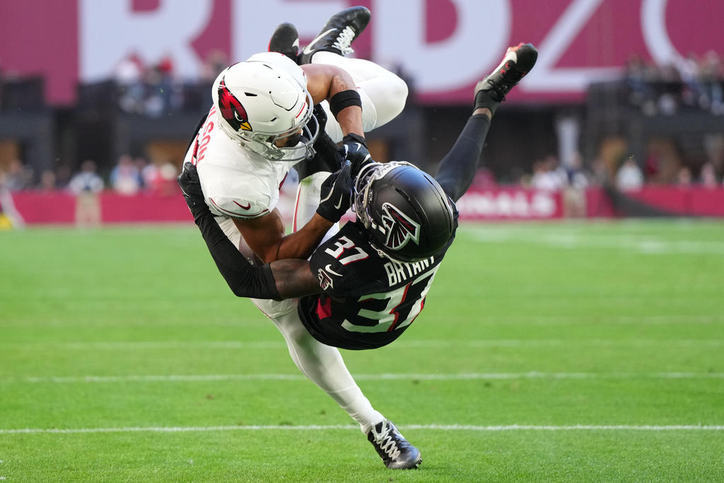 Arizona Cardinals wide receiver Michael Wilson (14) scores a touchdown against Atlanta Falcons cornerback Cobee Bryant (37) during the first half of an NFL football game, Sunday, Dec. 21, 2025, in Glendale, Ariz. (AP Photo/Rick Scuteri)