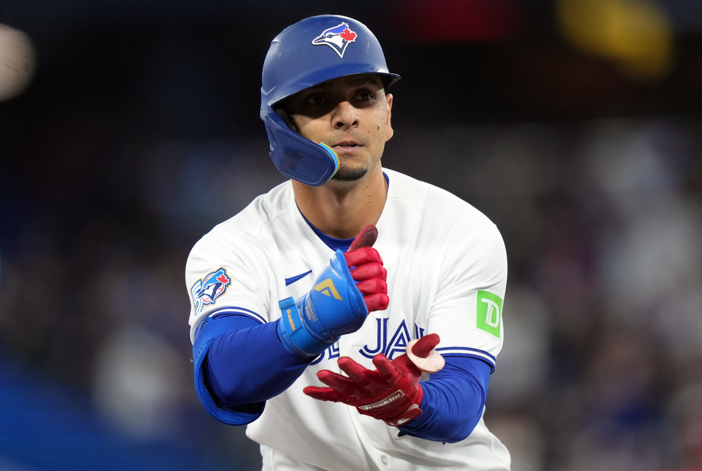 Toronto Blue Jays Andrés Giménez (0) reacts after hitting a triple against the Athletics during the fifth inning of a baseball game in Toronto on Friday, March 27, 2026. (Nathan Denette/The Canadian Press via AP)