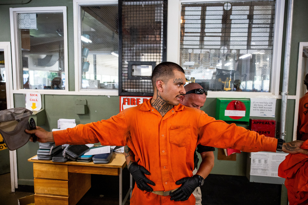 Damien Rubalcava, left, is patted down after work at the Pine Grove Youth Conservation Camp, July 14, 2025, in Red Corral, Calif. (AP Photo/Ethan Swope)