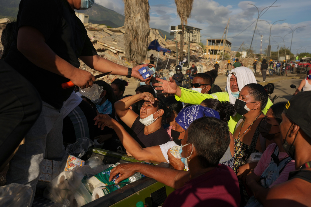 FILE - People affected by the earthquakes line up for food in La Guaira, Venezuela, June 28, 2026. (AP Photo/Matias Delacroix, File)