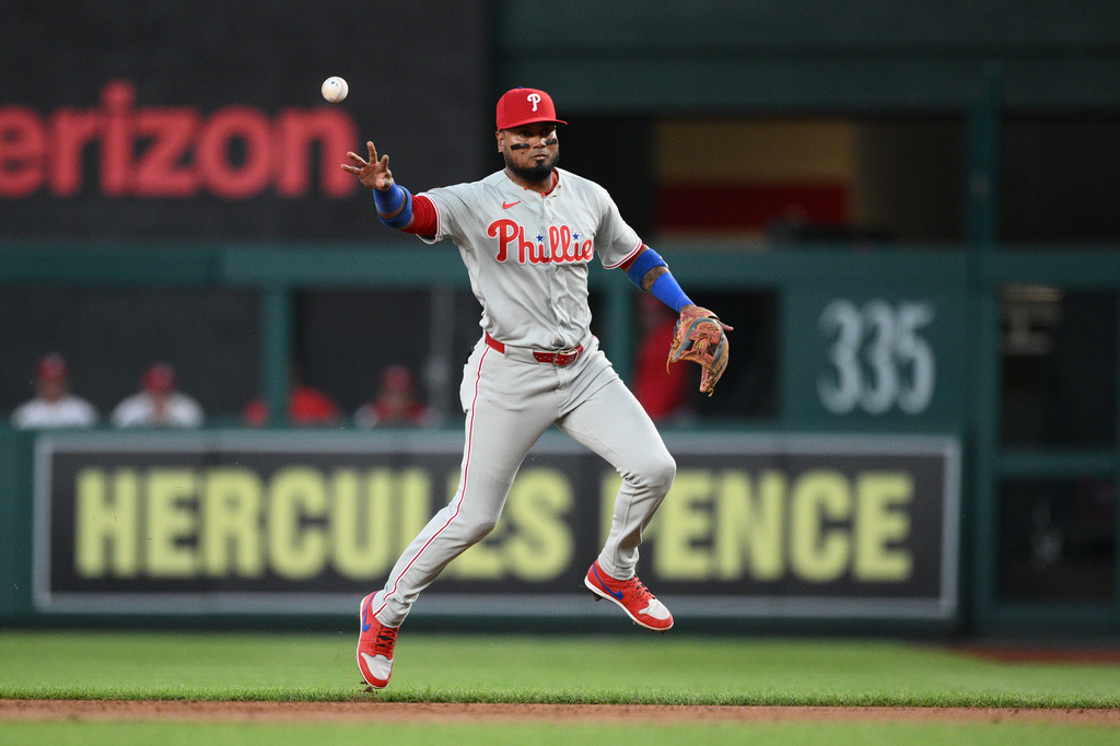 Philadelphia Phillies second baseman Luis Arraez tosses to first base to put out Washington Nationals' Abimelec Ortiz during the first inning of a baseball game, Wednesday, Sept. 16, 2026, in Washington. (AP Photo/Nick Wass)