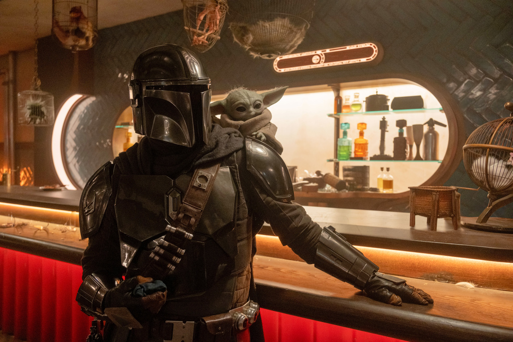 This image released by Disney shows The Mandalorian, portrayed by Pedro Pascal, left, and Grogu in a scene from Lucasfilm's "Star Wars: The Mandalorian and Grogu." (Nicola Goode/Lucasfilm Ltd. - Disney via AP)