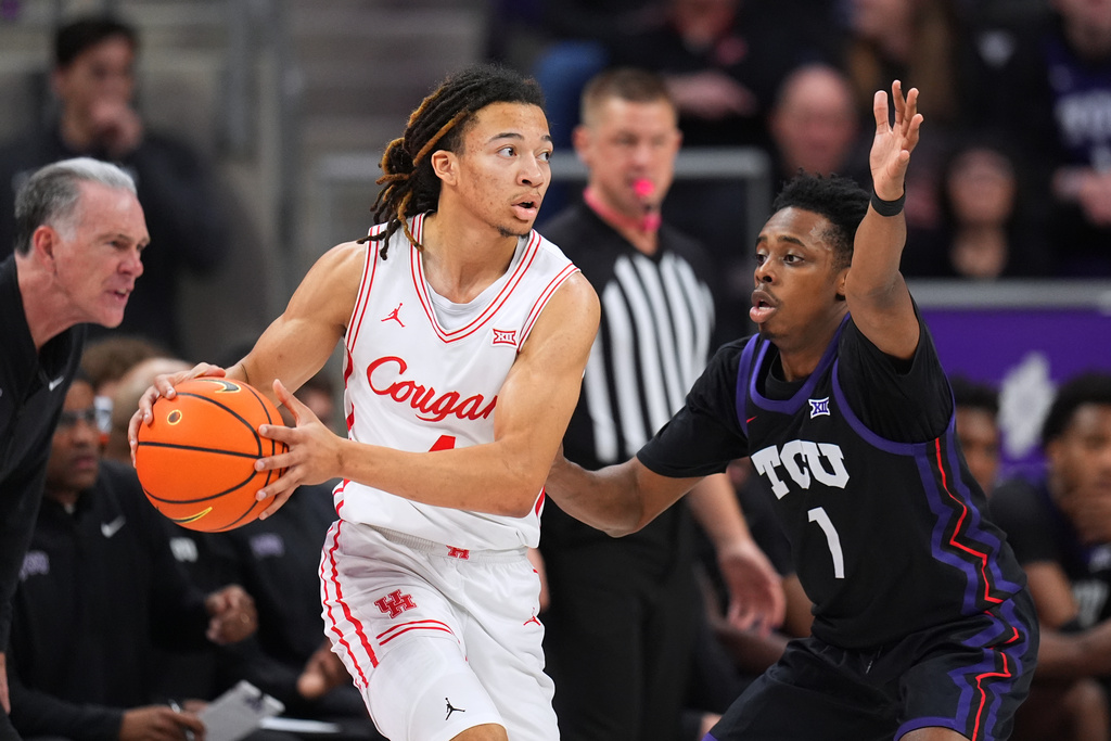 Houston guard Kingston Flemings, left, works the floor against TCU guard Jayden Pierre during the first half of an NCAA college basketball game Wednesday, Jan. 28, 2026, in Fort Worth, Texas. (AP Photo/Julio Cortez)