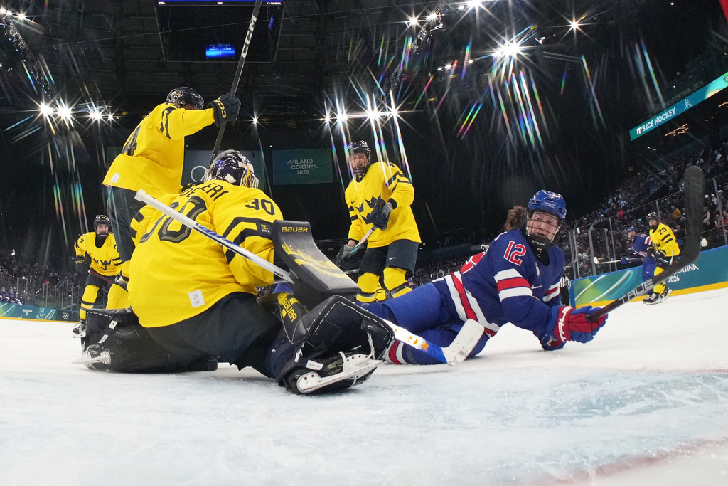 United States' Kelly Pannek (12) challenges with Sweden's Emma Soderberg (30) during a women's ice hockey semifinal game between the United States and Sweden at the 2026 Winter Olympics, in Milan, Italy, Monday, Feb. 16, 2026. (David W Cerny/Pool Photo via AP)