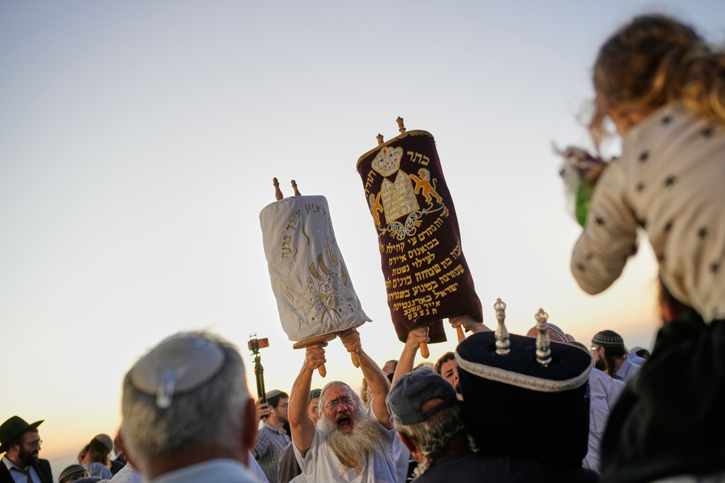 Israeli settlers celebrate the inauguration of a newly built synagogue at the occupied West Bank illegal outpost of Homesh, Wednesday, Sept. 16, 2026. (AP Photo/Ohad Zwigenberg)