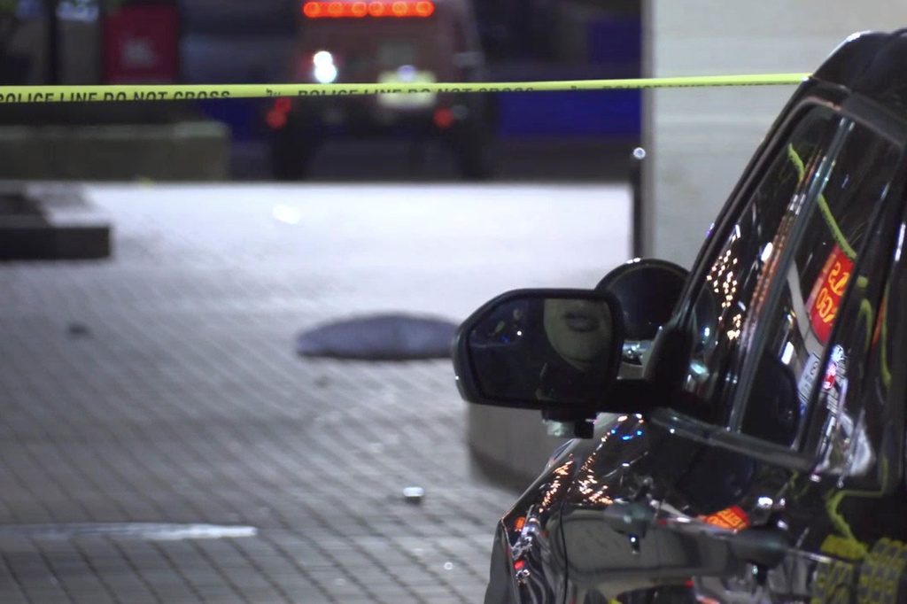 This image made from video provided by KCRG shows Iowa City police officers working the scene of a downtown shooting near the University of Iowa campus on Sunday, April 19, 2026. (KCRG via AP)