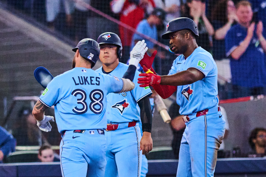 Toronto Blue Jays' Nathan Lukes, left, celebrates his three-run home run against the Kansas City Royals with with Kazuma Okamoto, center, and Jesus Sanchez, right, during the fourth inning of a baseball game in Toronto, Wednesday, Aug. 26, 2026. (Sammy Kogan/The Canadian Press via AP)