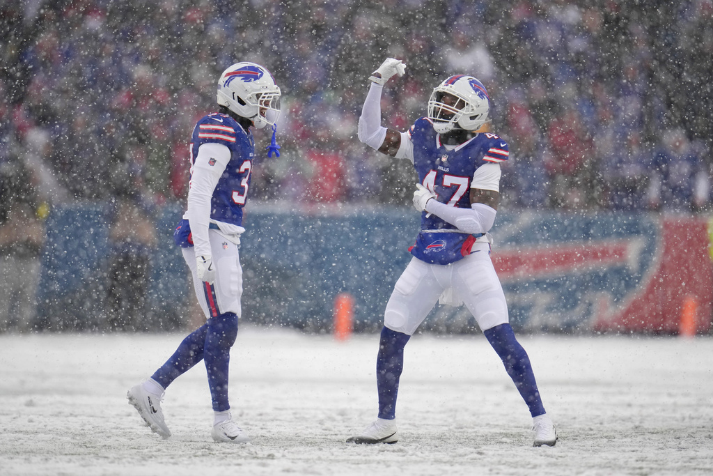 Buffalo Bills cornerback Christian Benford (47) celebrates sacking Cincinnati Bengals quarterback Joe Burrow with teammate cornerback Jordan Hancock (37) during the first half of an NFL football game, Sunday, Dec. 7, 2025, in Orchard Park, N.Y. (AP Photo/Gene J. Puskar)