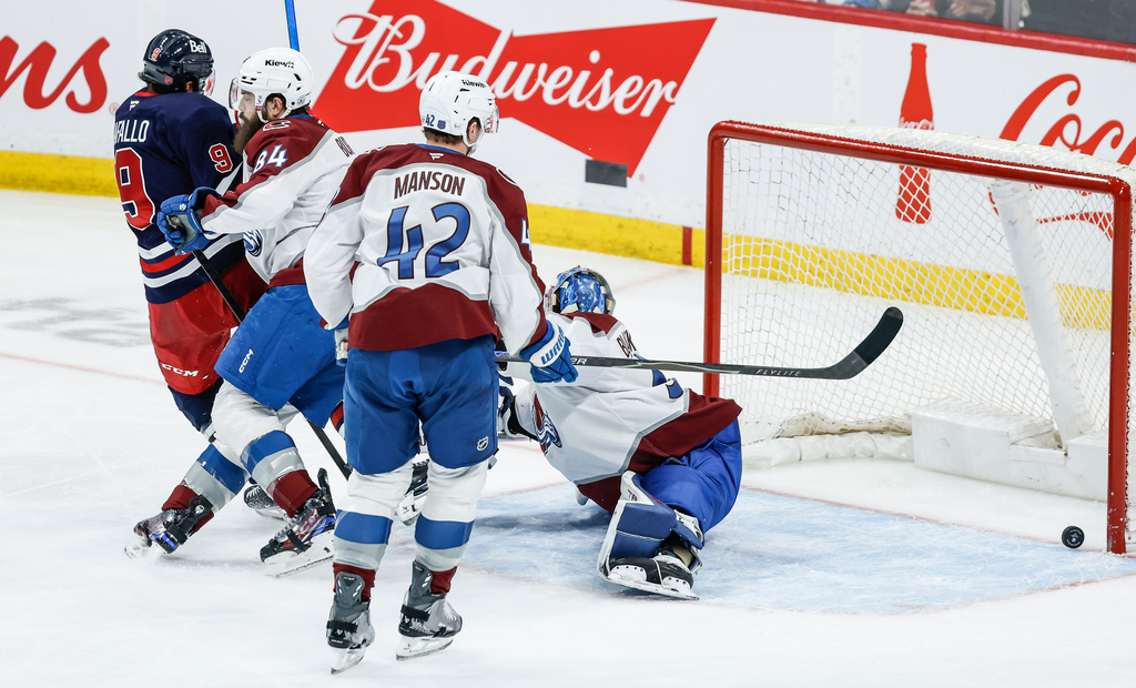 Winnipeg Jets' Alex Iafallo (9) scores on Colorado Avalanche goaltender Mackenzie Blackwood (39) during the second period of an NHL game in Winnipeg, Saturday, March 14, 2026. (John Woods/The Canadian Press via AP)
