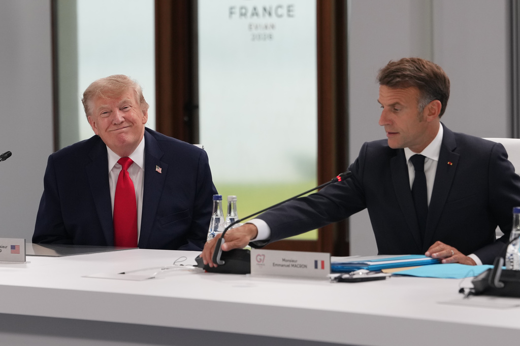 U.S. President Donald Trump participates in a working session with French President Emmanuel Macron, right, other leaders during the G7 summit, Tuesday, June 16, 2026, in Evian-les-Bains, France. (AP Photo/Julia Demaree Nikhinson)