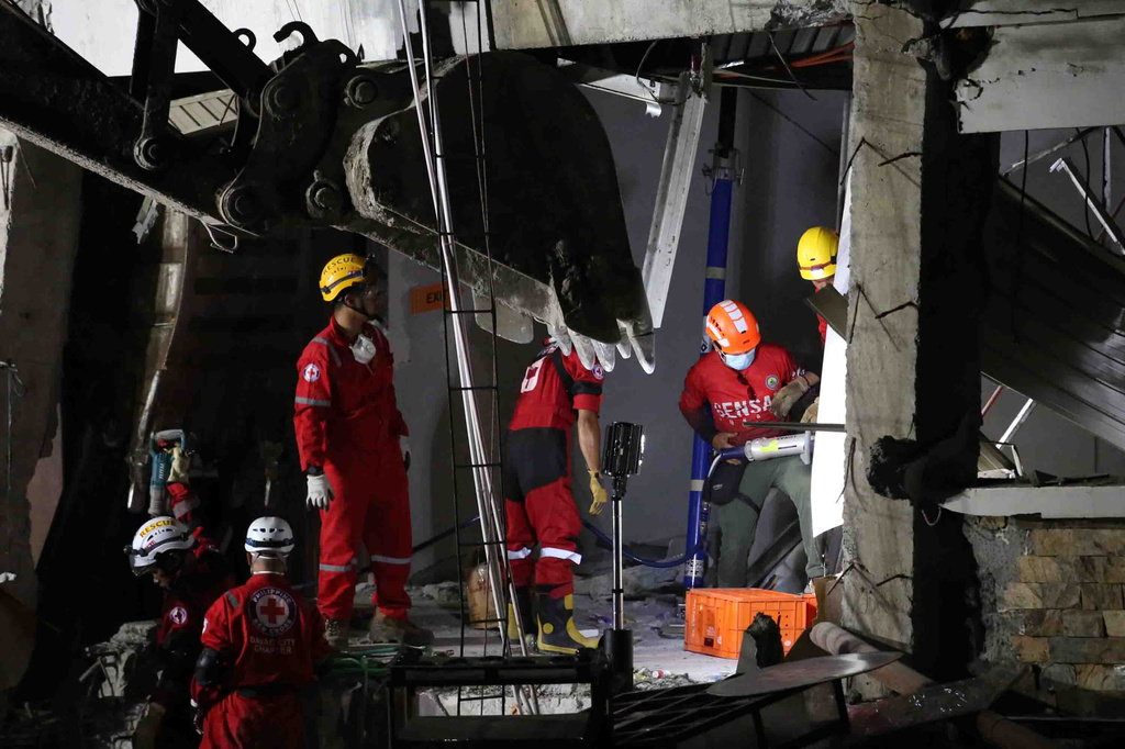 Rescuers use heavy equipment as they conduct a search and retrieval operation at a damaged building following an earthquake in General Santos, Philippines, Tuesday, June 9, 2026. (AP Photo/Basilio Sepe)