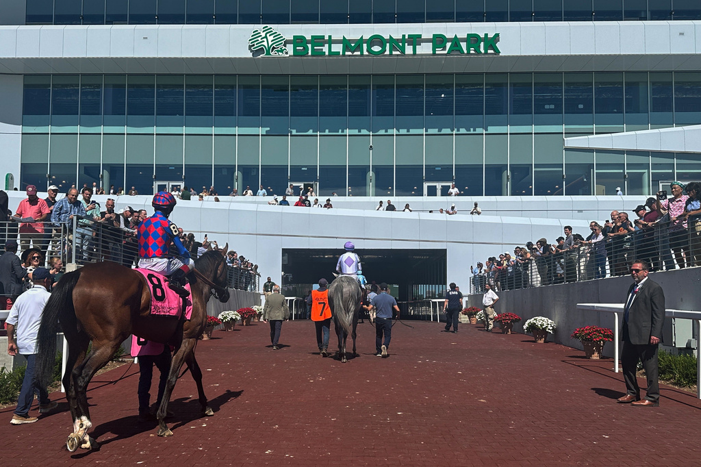 In this photo made with a smartphone, jockeys ride their horses into the newly-opened Belmont Park in Elmont, N.Y., on Friday, Sept. 18, 2026. (AP Photo/Stephen Whyno)