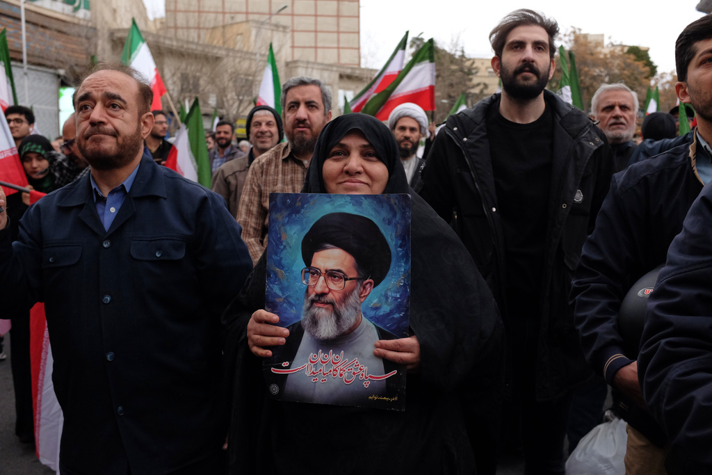 A woman holds a picture of the Iranian Supreme Leader Ayatollah Ali Khamenei during a demonstration in support of the government and against U.S. and Israeli strikes in Tehran, Iran, Saturday, Feb. 28, 2026. (AP Photo/Vahid Salemi)