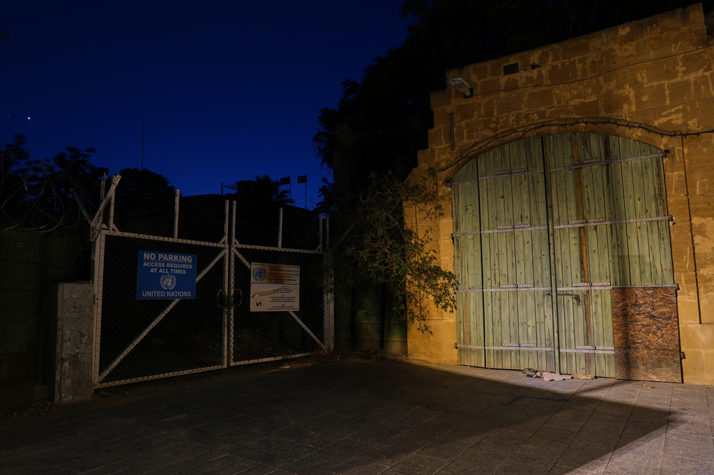 A gate used by U.N peacekeepers separates the Greek Cypriot south from the Turkish Cypriot north along the U.N.-controlled buffer zone, established after the July 20, 1974 Turkish invasion of Cyprus, in the medieval core of the divided capital, Nicosia, Cyprus, on July 7, 2026. (AP Photo/Petros Karadjias)