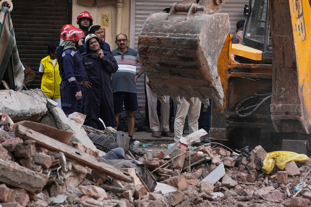 Rescuers clear debris as they search for people possibly trapped at the site of a collapsed building in New Delhi, India, Monday, Sept. 7, 2026. (AP Photo/Manish Swarup)