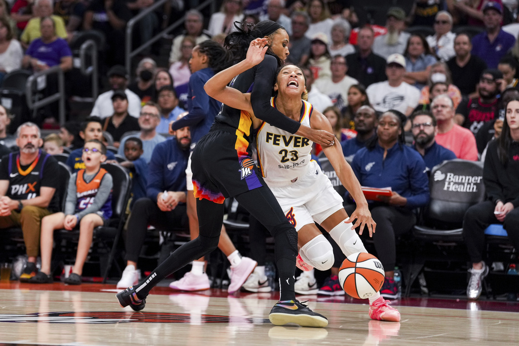 Phoenix Mercury forward DeWanna Bonner, left, fouls Indiana Fever guard Aerial Powers (23) during the first half of a WNBA basketball game, Tuesday, Sept. 2, 2025, in Phoenix. (AP Photo/Samantha Chow)