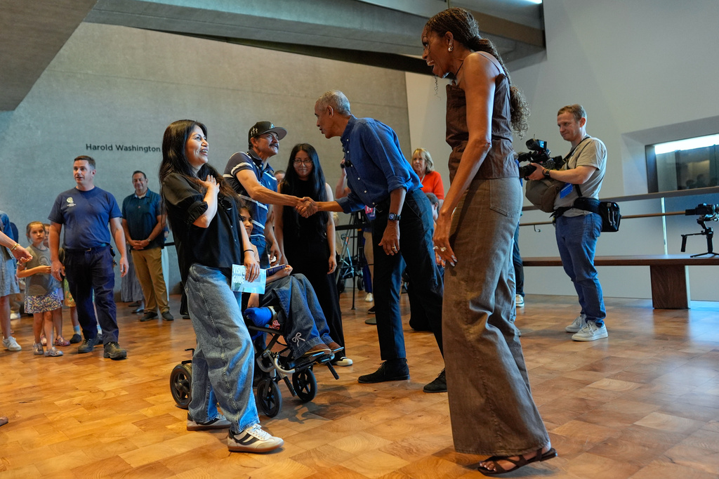 Former President Barack Obama and former first lady Michelle Obama greet the first group of visitors at the official opening of the Obama Presidential Center in Chicago, Friday, June 19, 2026. (AP Photo/Pablo Martinez Monsivais, Pool)