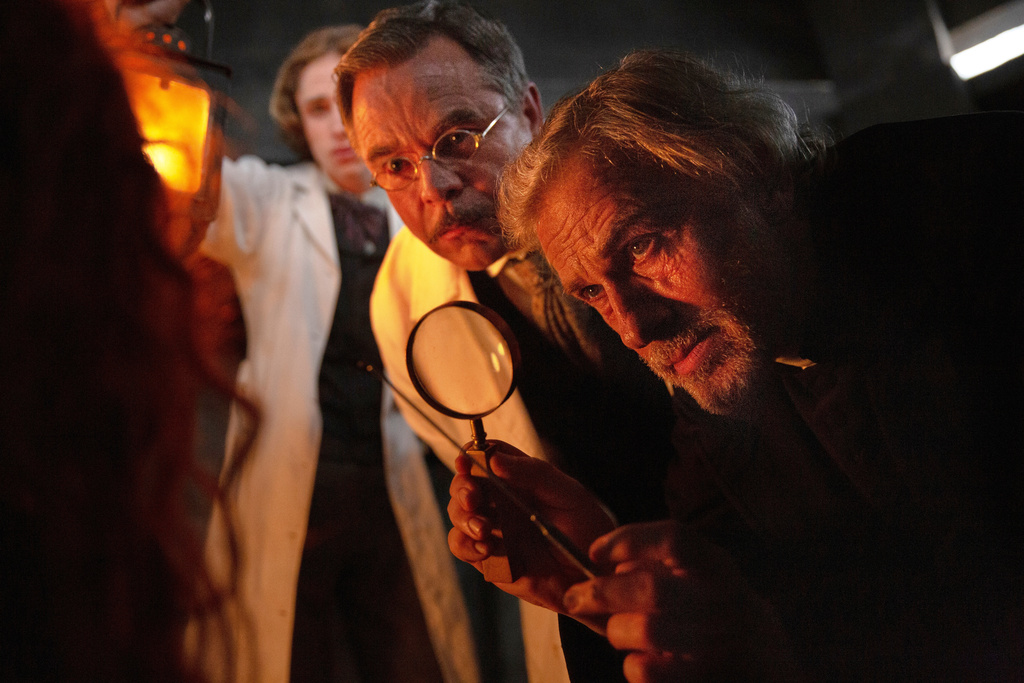 This image released by Vertical Entertainment shows from right, Christoph Waltz, Guillaume de Tonquédec, and Raphael Luce, in a scene from "Dracula." (Vertical Entertainment via AP)