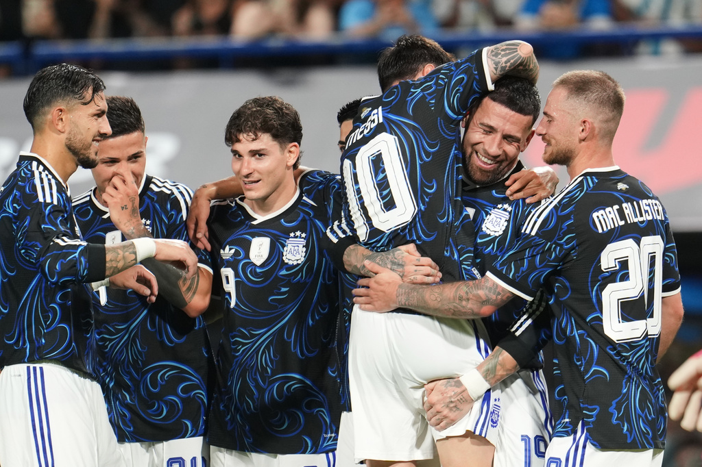 Temmates congratulate Argentina's Nicolas Otamendi after he scored his side's third goal against Zambia during a friendly soccer match in Buenos AIres, Argentina, Tuesday, March 31, 2026. (AP Photo/Rodrigo Abd)