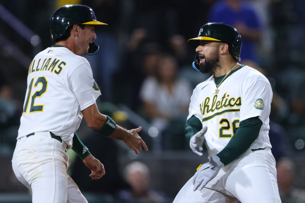 Athletics' Carlos Cortes, right, celebrates with teammate Alika Williams (12) after hitting a go ahead two-run home run during the eighth inning of a baseball game against the Los Angeles Angels Tuesday, Sept. 22, 2026, in West Sacramento, Calif. (AP Photo/Scott Marshall)