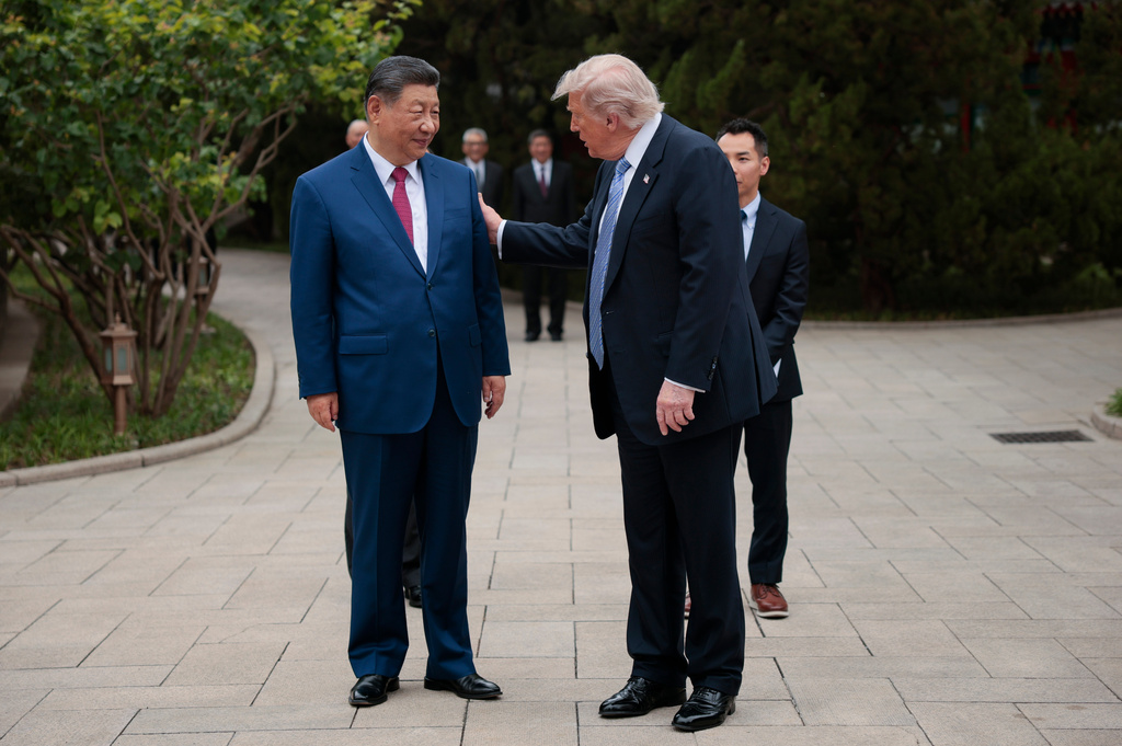 U.S. President Donald Trump speaks with Chinese President Xi Jinping, left, while leaving after a visit to the Zhongnanhai Garden in Beijing, Friday, May 15, 2026. (Evan Vucci/Pool Photo via AP)