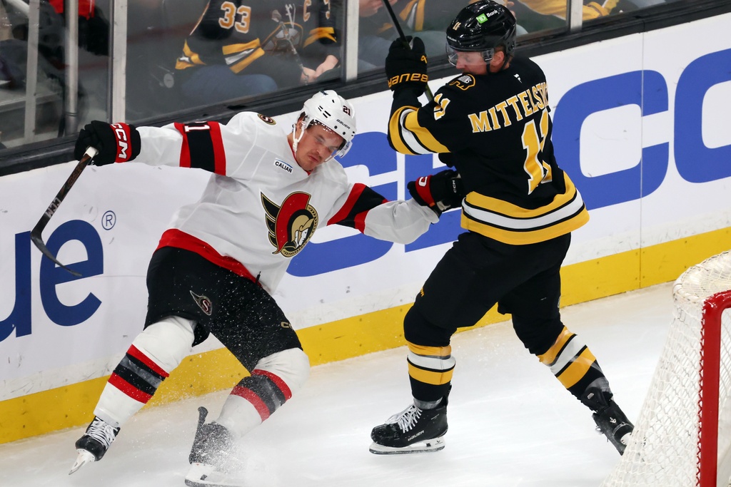 Boston Bruins' Casey Mittelstadt, right, checks Ottawa Senators' Nick Cousins, left, during the first period of an NHL hockey game, Thursday, Nov. 6, 2025, in Boston. (AP Photo/Michael Dwyer)