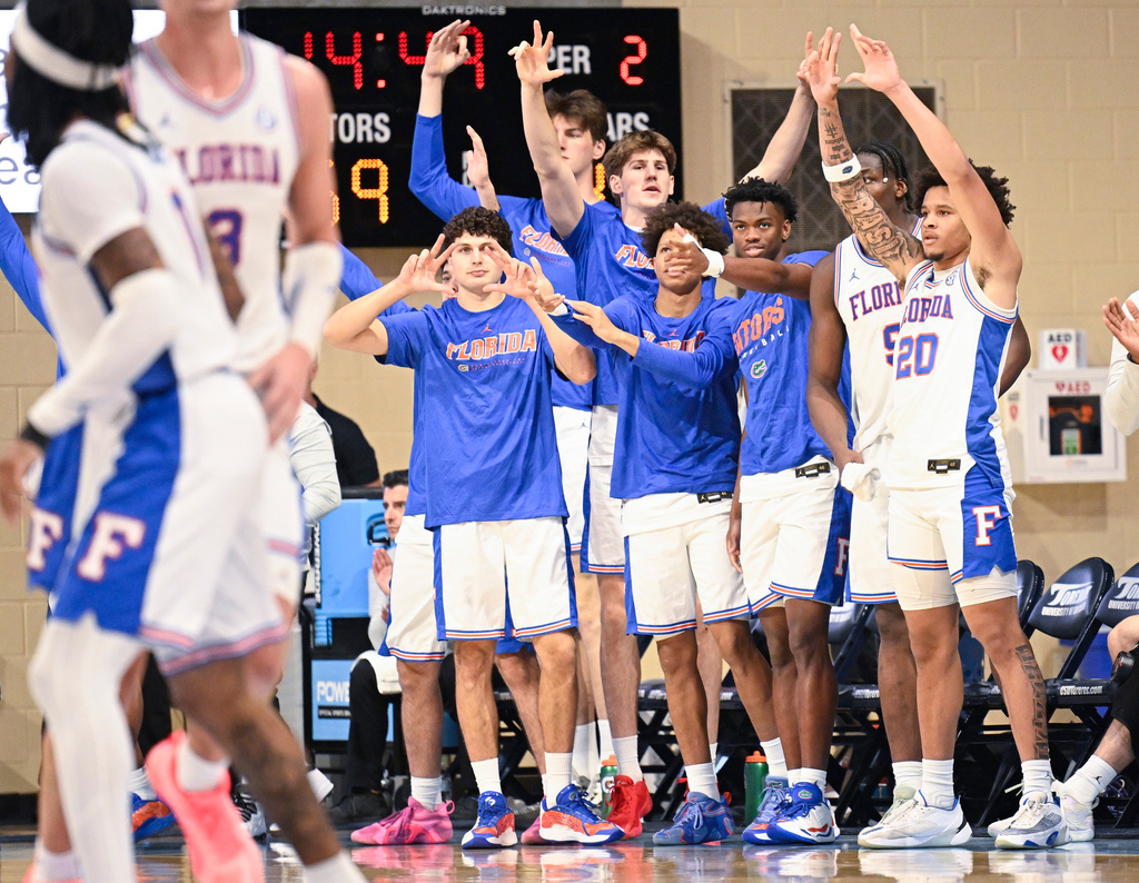 Florida players celebrate after a 3-point basket during the second half of an NCAA college basketball game against Providence in the Rady Children's Invitational tournament Friday, Nov. 28, 2025, in San Diego. (AP Photo/Denis Poroy)