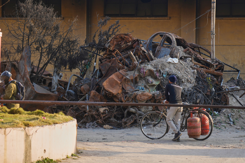 FILE - A person carries gas cylinders on his bicycle in Kathmandu, on March 19, 2026. (AP Photo/Niranjan Shrestha, File)