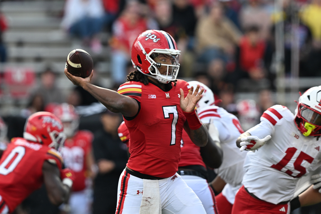 Maryland quarterback Malik Washington (7 ) throws a pass against Nebraska during the first half of a NCAA college football game, Saturday, Oct. 11, 2025, in College Park, Md. (AP Photo/Gail Burton)