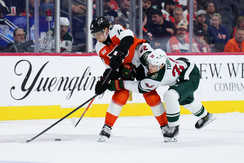 Philadelphia Flyers' Owen Tippett, left, and Minnesota Wild's Danila Yurov, right, collide during the first period of an NHL hockey game, Saturday, Oct. 18, 2025, in Philadelphia. (AP Photo/Derik Hamilton)