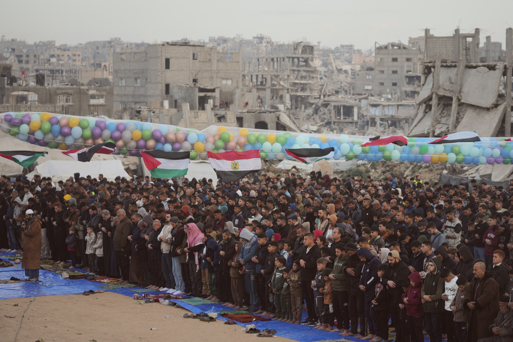 Palestinian Muslims offer Eid al-Fitr prayers amid the rubble of destroyed buildings in Jabaliya, Gaza Strip, Friday, March 20, 2026. (AP Photo/Jehad Alshrafi)